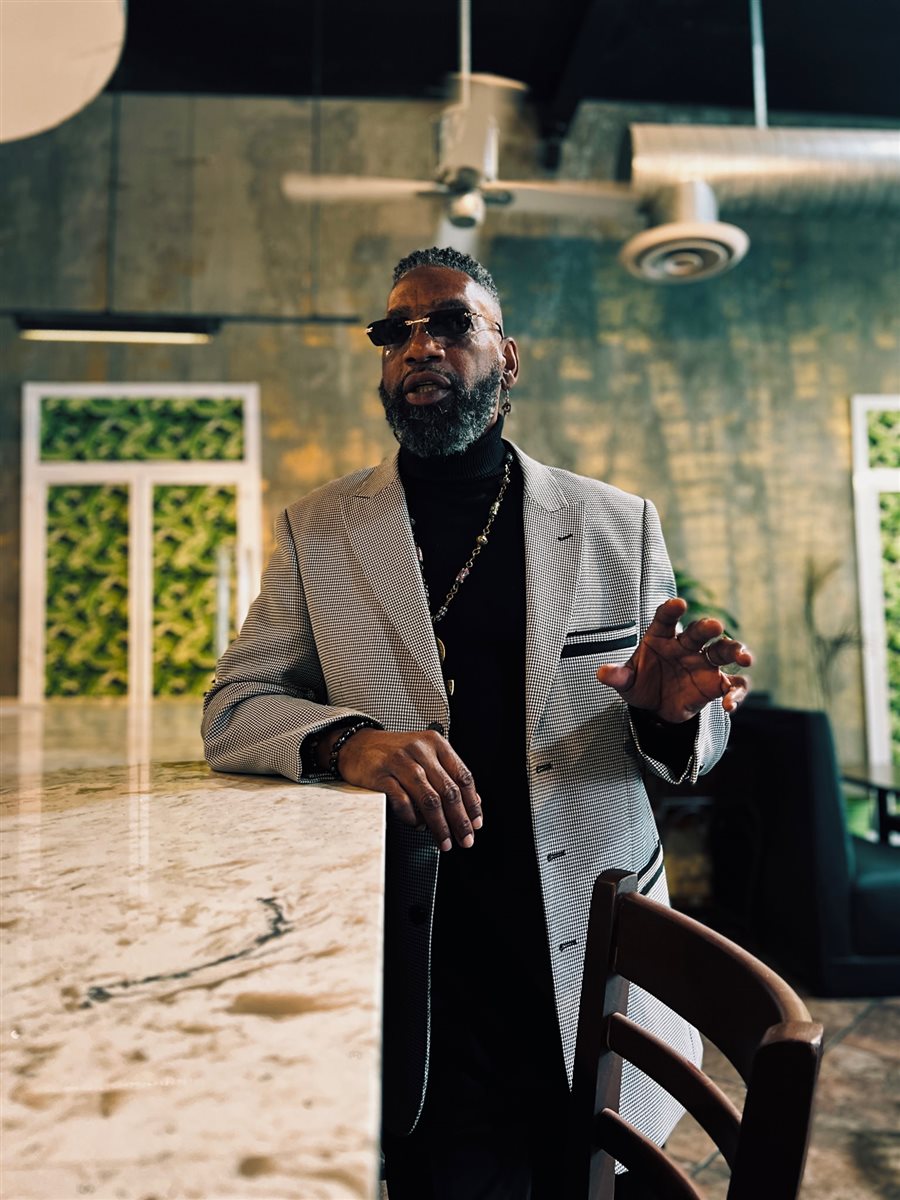 Prophet O standing at a marble counter, speaking